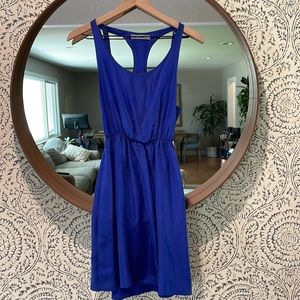 Royal blue silk dress. Racerback w/ grommet strap detail. Cinched waste w/pocket
